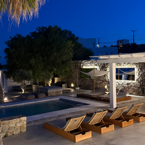 Außenansicht mit Pool und Liegen von Casa Mykonos in der Nacht